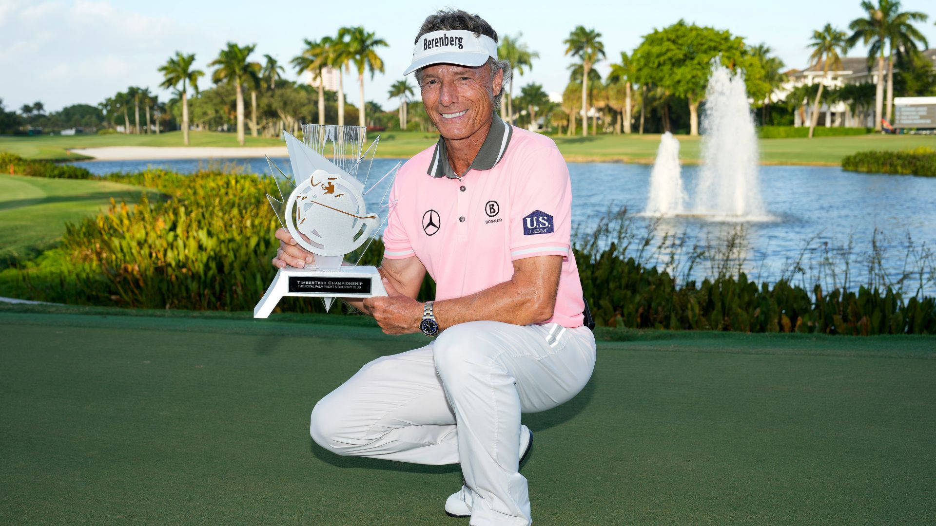 Bernhard Langer Crouching And Holding Trophy Background