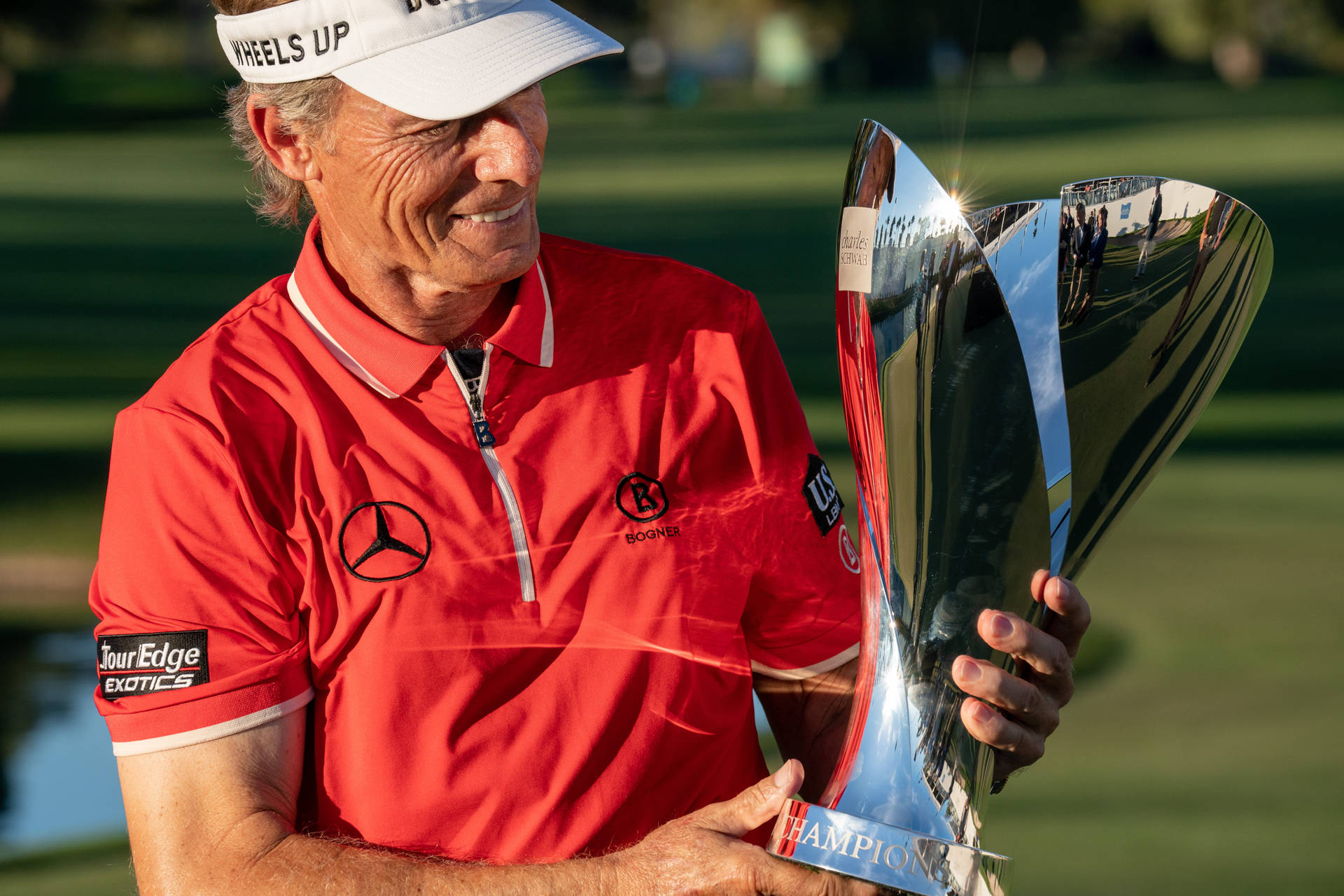 Bernhard Langer Looking At His Trophy Background