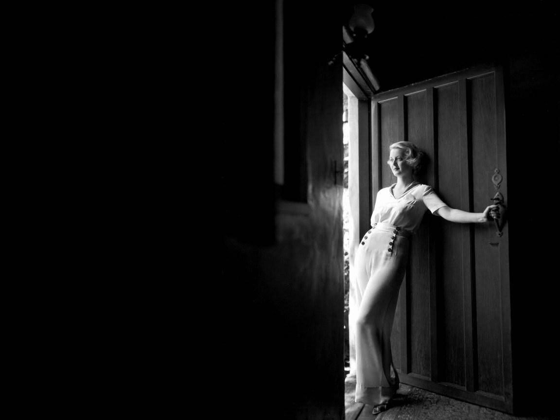 Bette Davis Posing In A Door Background