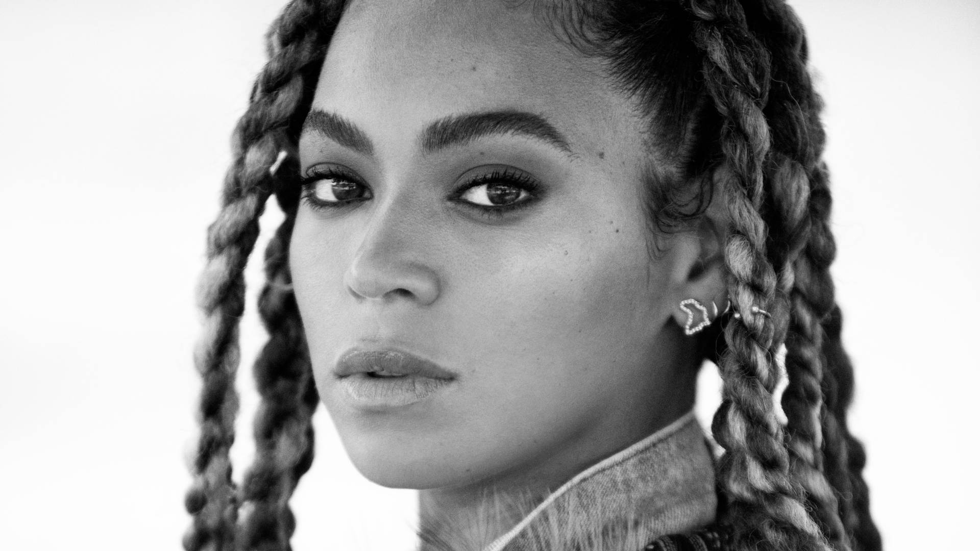 Beyonce Wears Her Signature Braids With Statement Earrings Background