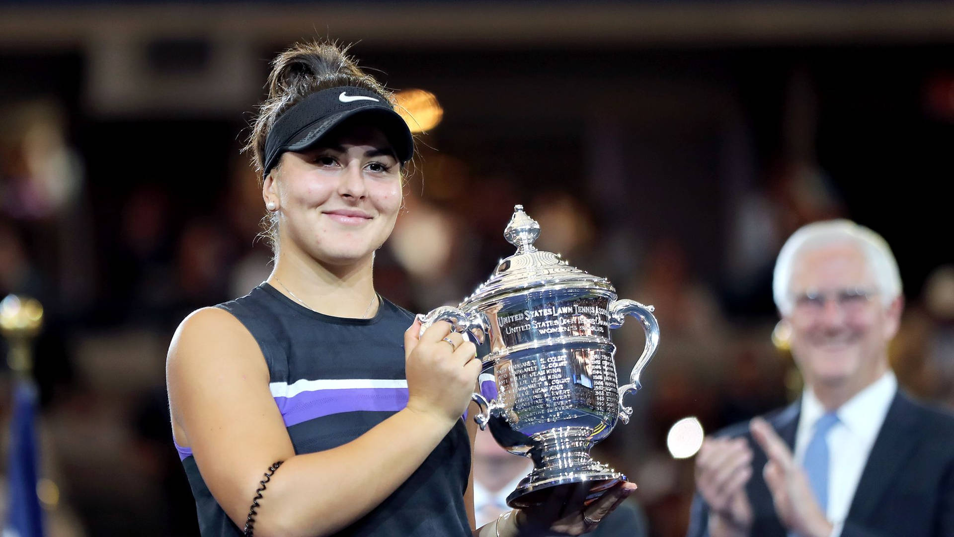 Bianca Andreescu Holding Her Trophy Up Background