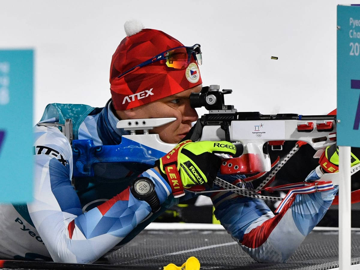 Biathlon Athlete Aiming With Precision Background