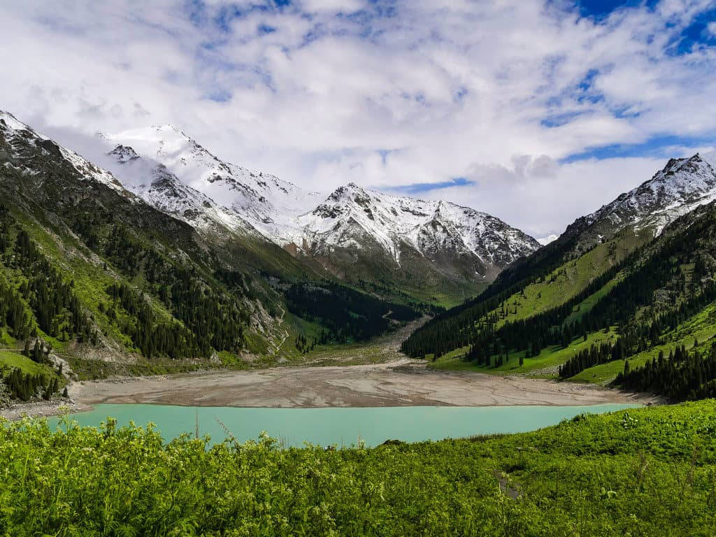 Big Almaty Lake Against Green Mountains Background