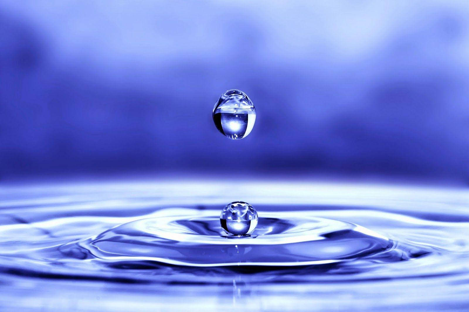 Big Droplet On Rippling Water Background