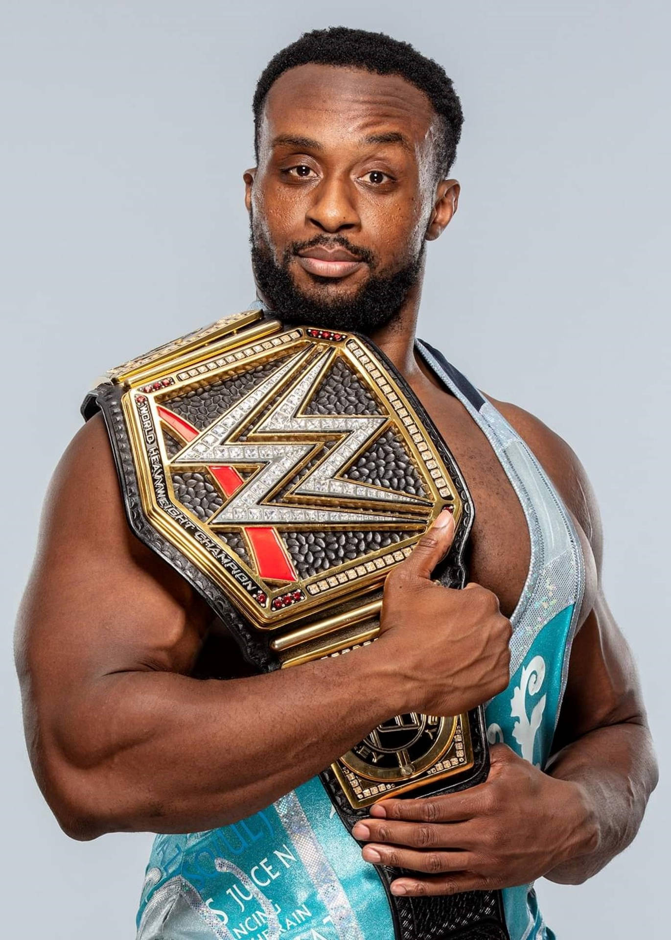 Big E Proudly Holding The World Heavyweight Championship Belt Background