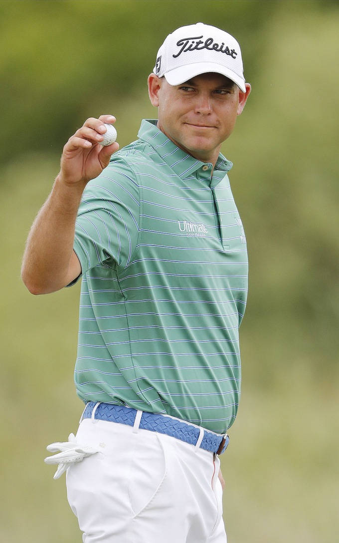 Bill Haas Holding A Golf Ball Background