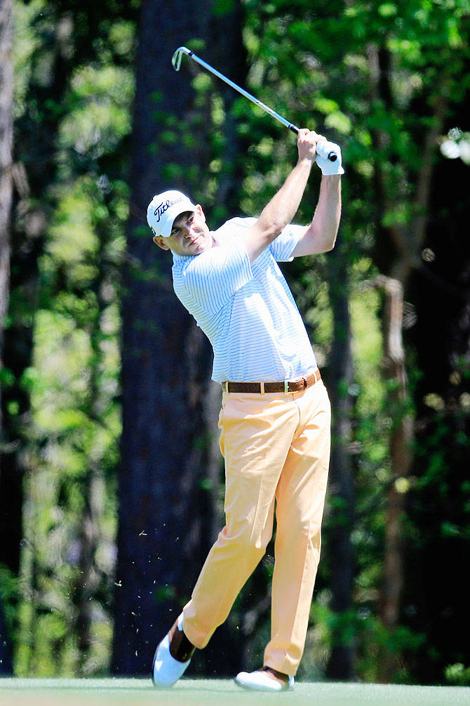 Bill Haas Striking A Ball Background