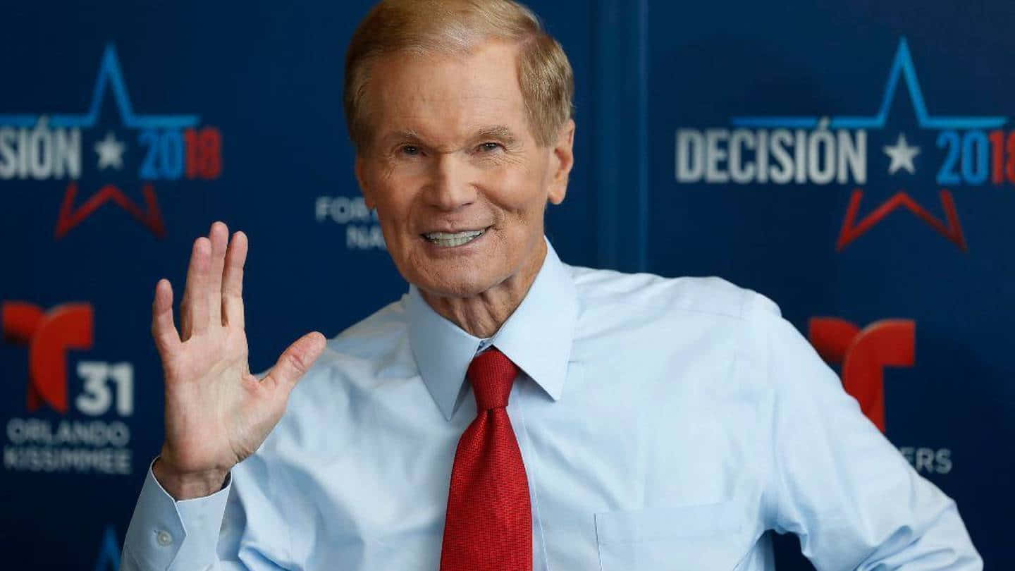 Bill Nelson Smiling And Raising His Hand Background