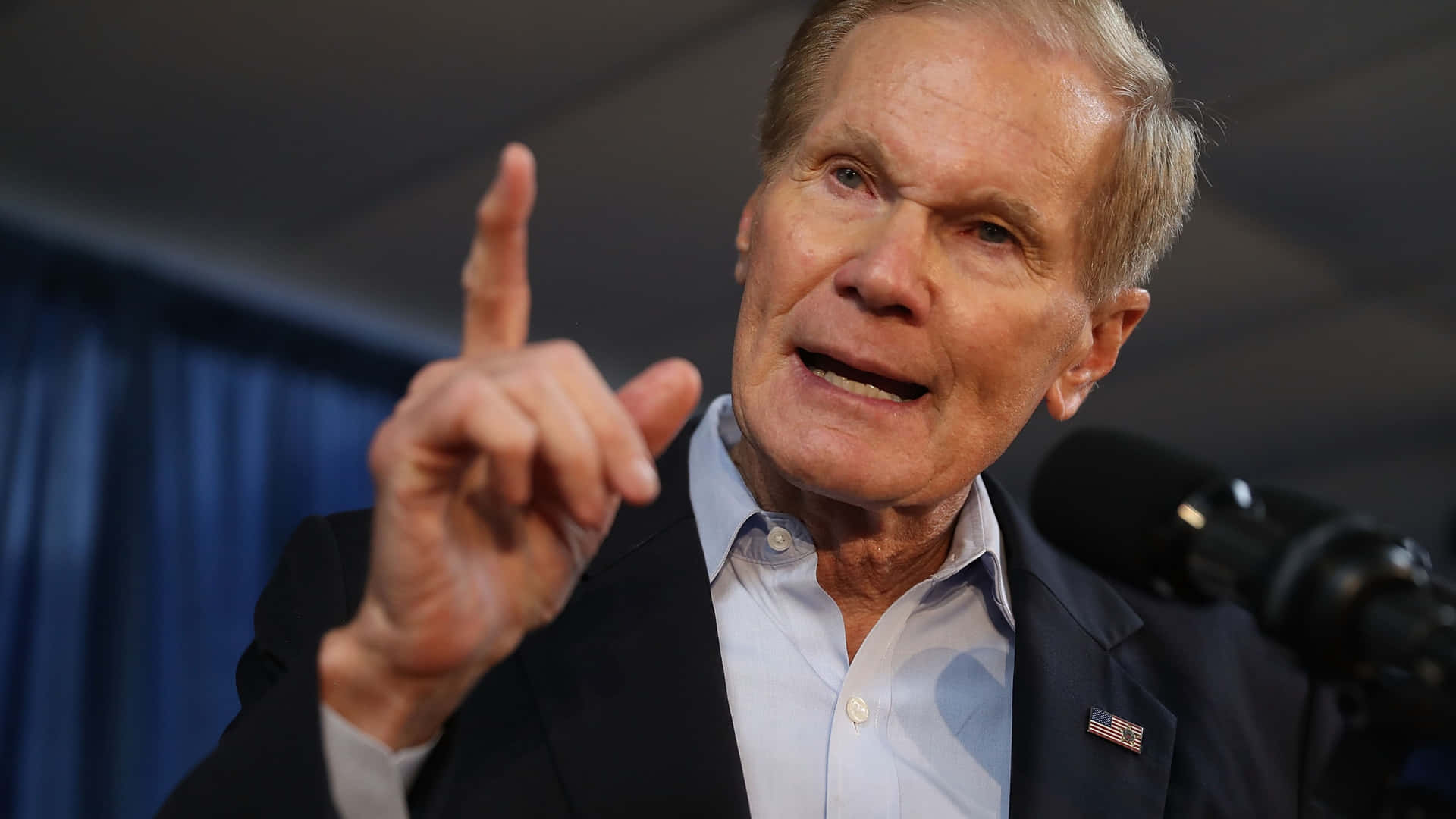 Bill Nelson Speaks Intensely In A Meeting Background