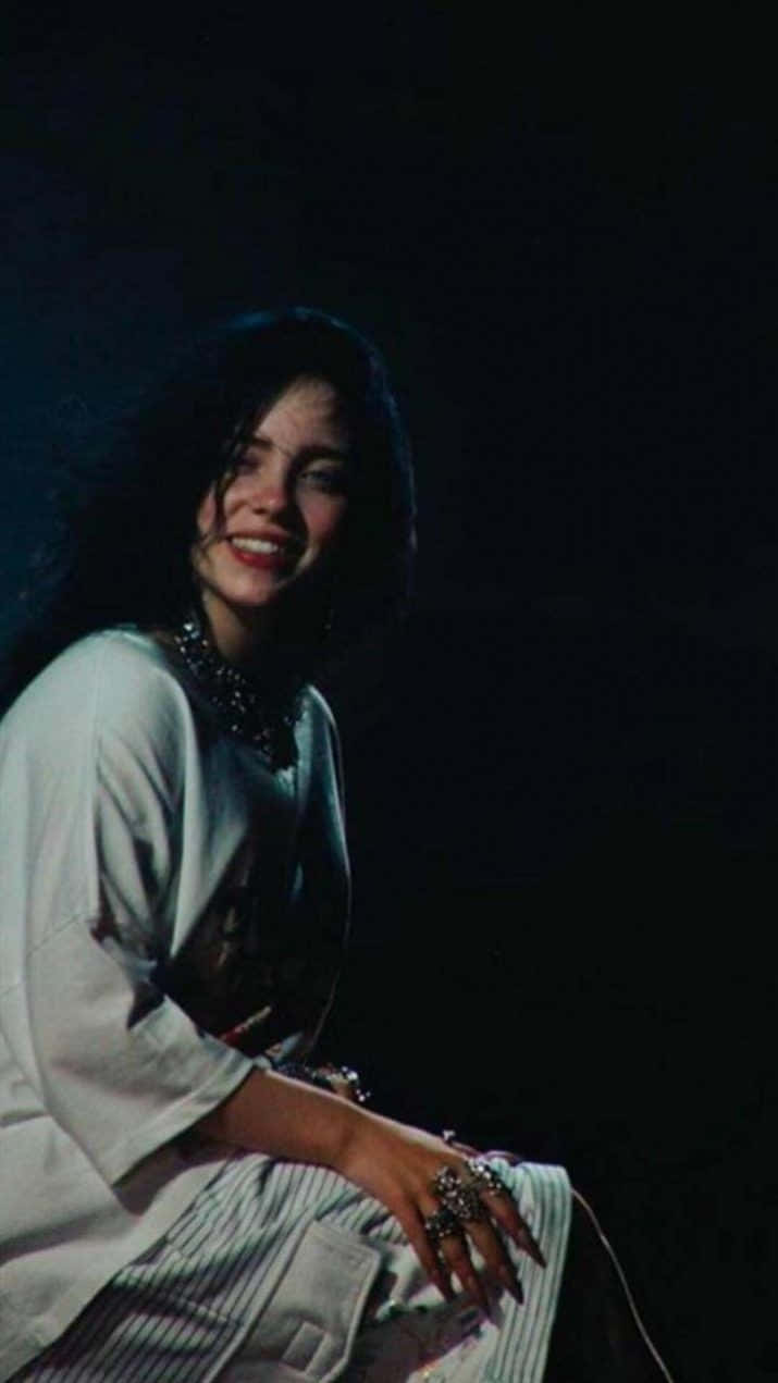 Billie Eilish Radiates Contagious Joy With Her Smile Background