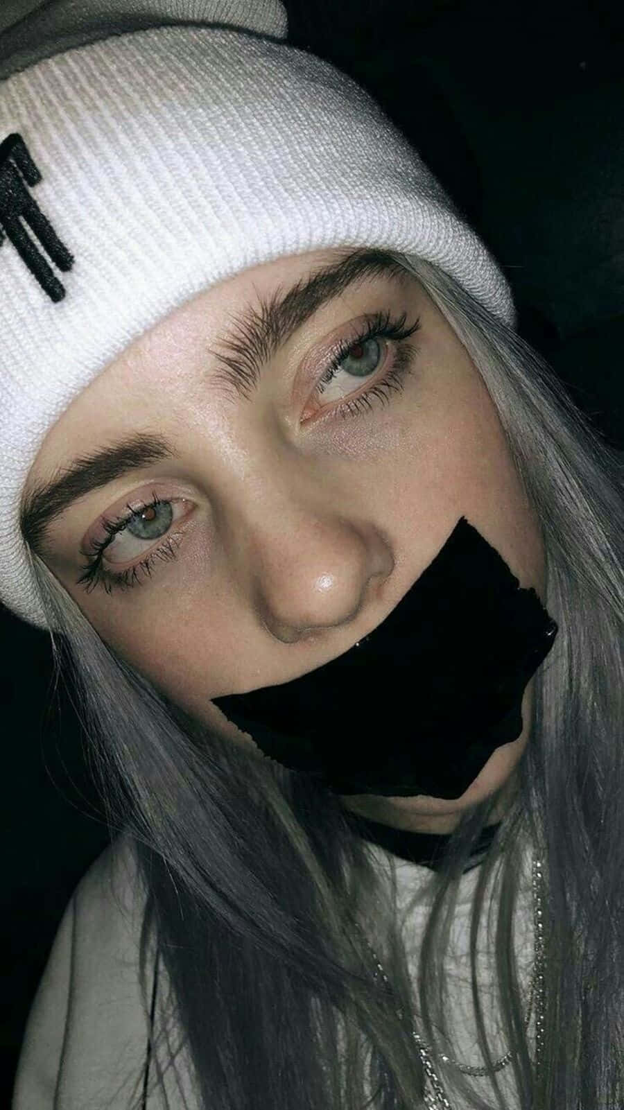 Billie Eilish Sad Expression With Tape Over Mouth Background