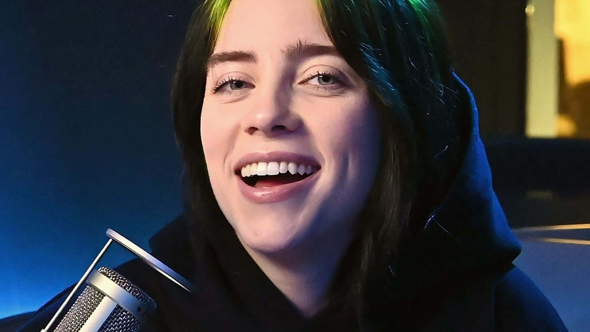 Billie Eilish Smiling Under The Setting Sun Background