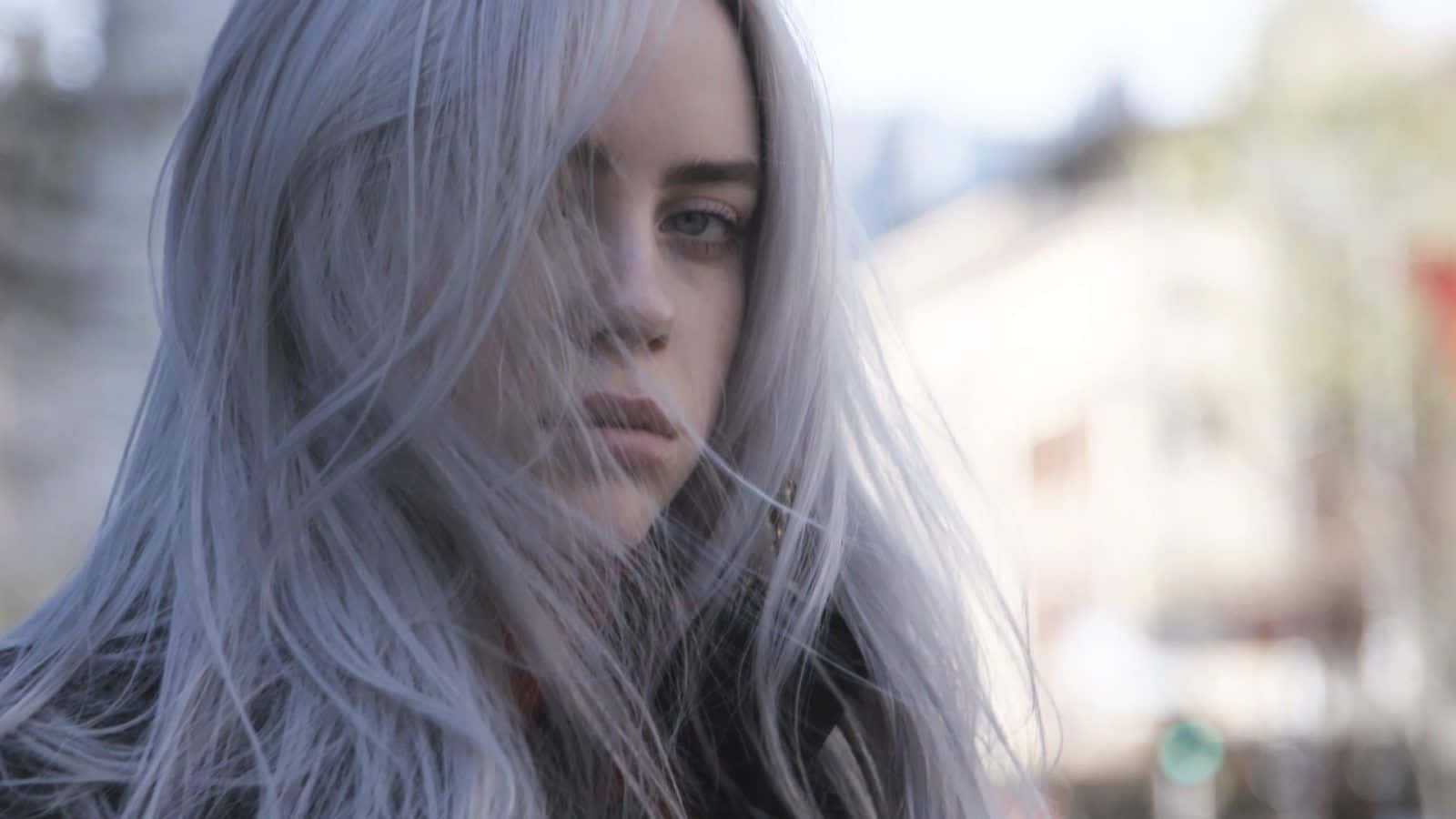 Billie Eilish Strikes A Pose In Front Of Her Laptop. Background