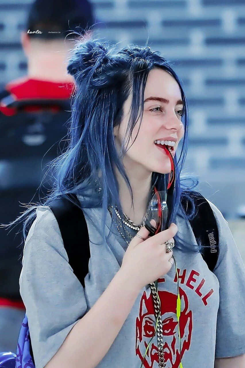 Billie Eilish Wearing Her Signature Smile Background