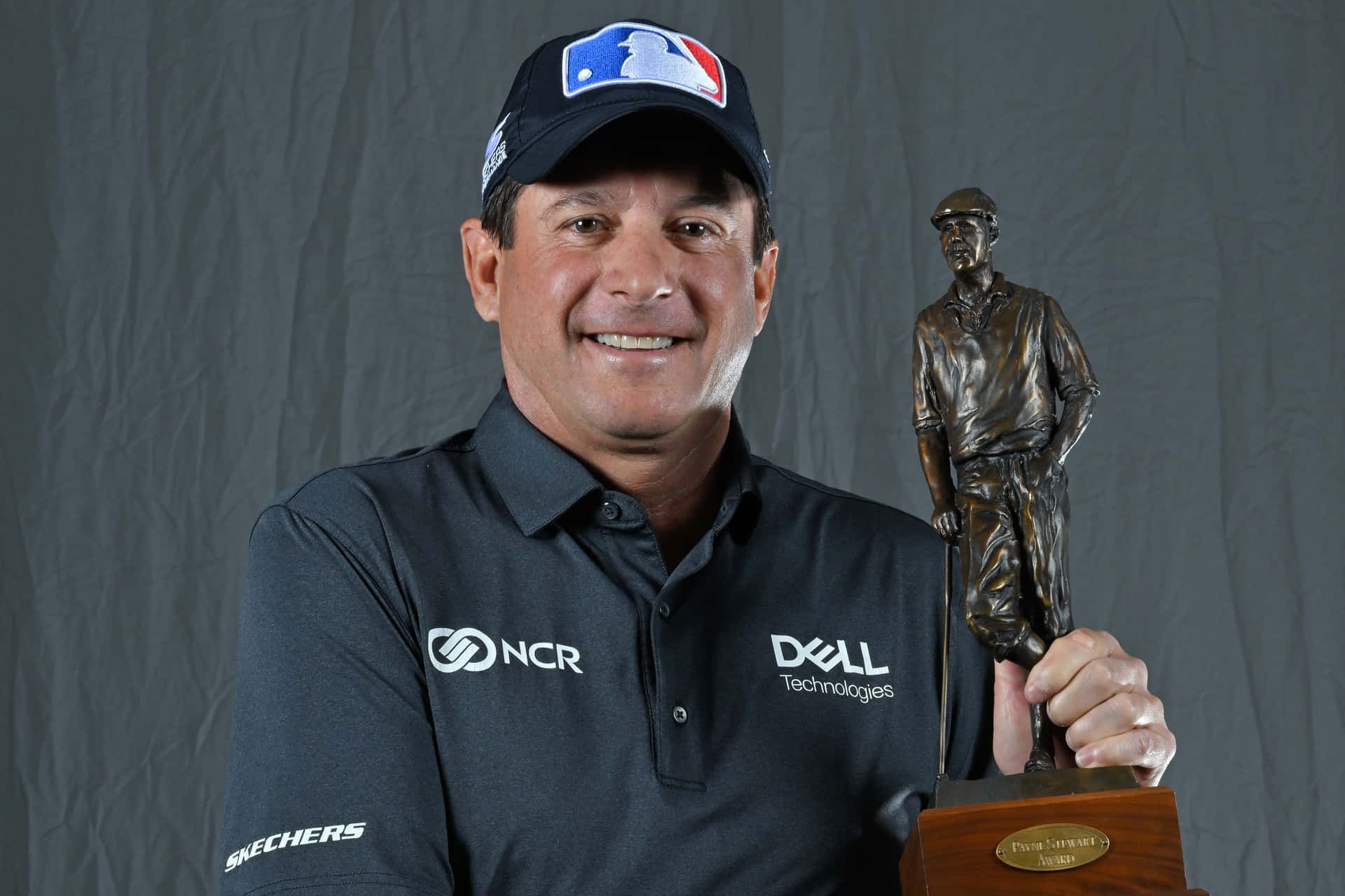 Billy Andrade Holding A Trophy Background
