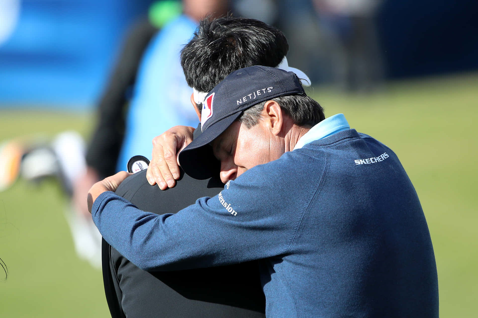 Billy Andrade Hugging Y. E. Yang Background