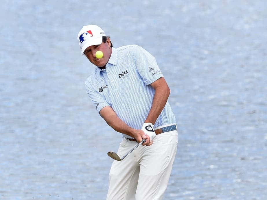 Billy Andrade Looking At A Golf Ball Background