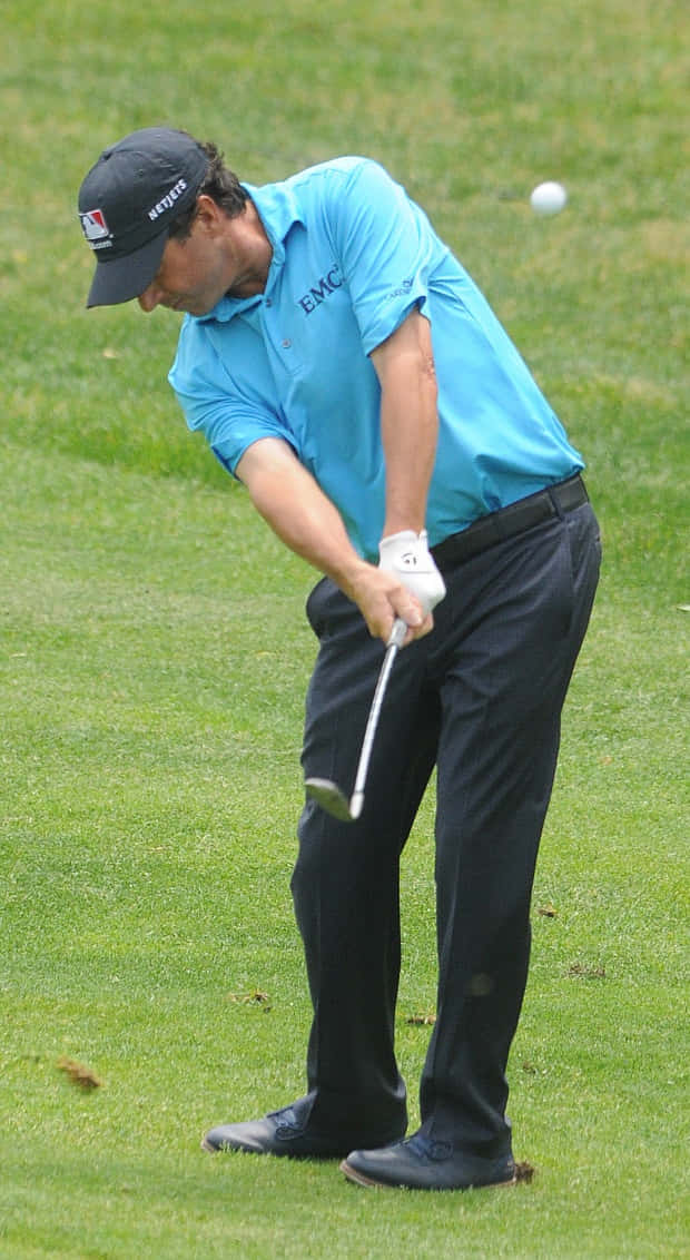 Billy Andrade Performs A Golf Swing Background