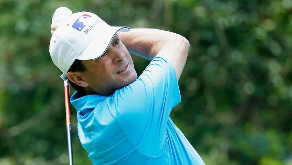 Billy Andrade Swings A Golf Club Background