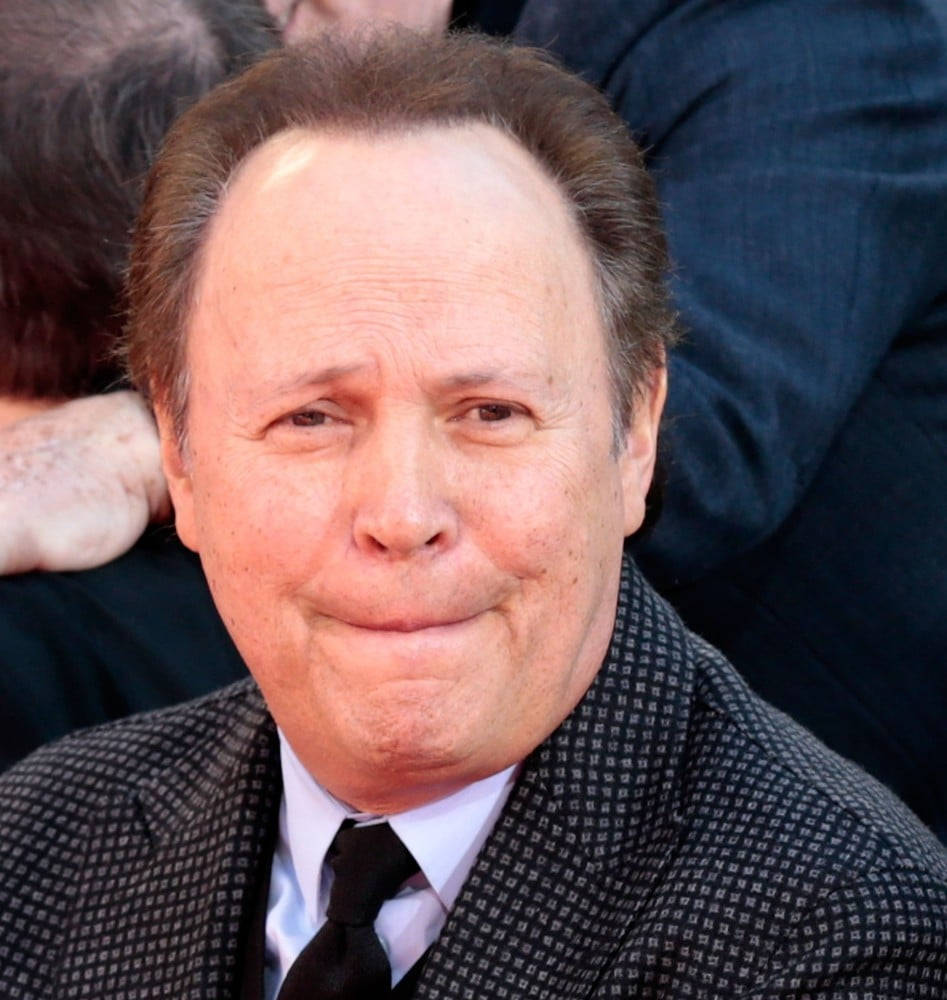 Billy Crystal Capturing Amusement With An Awkward Expression Background