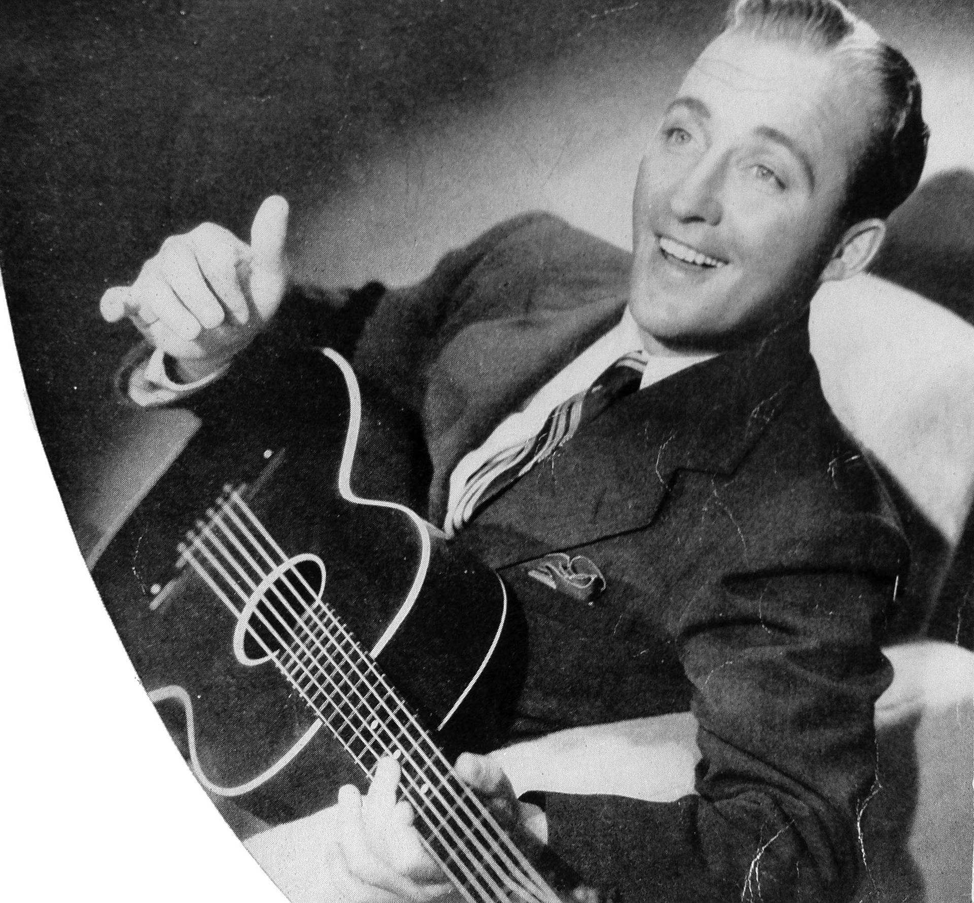 Bing Crosby Holding A Guitar Background