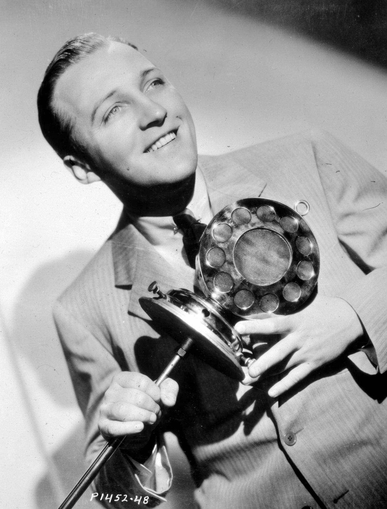 Bing Crosby Holding A Metal Staff Background