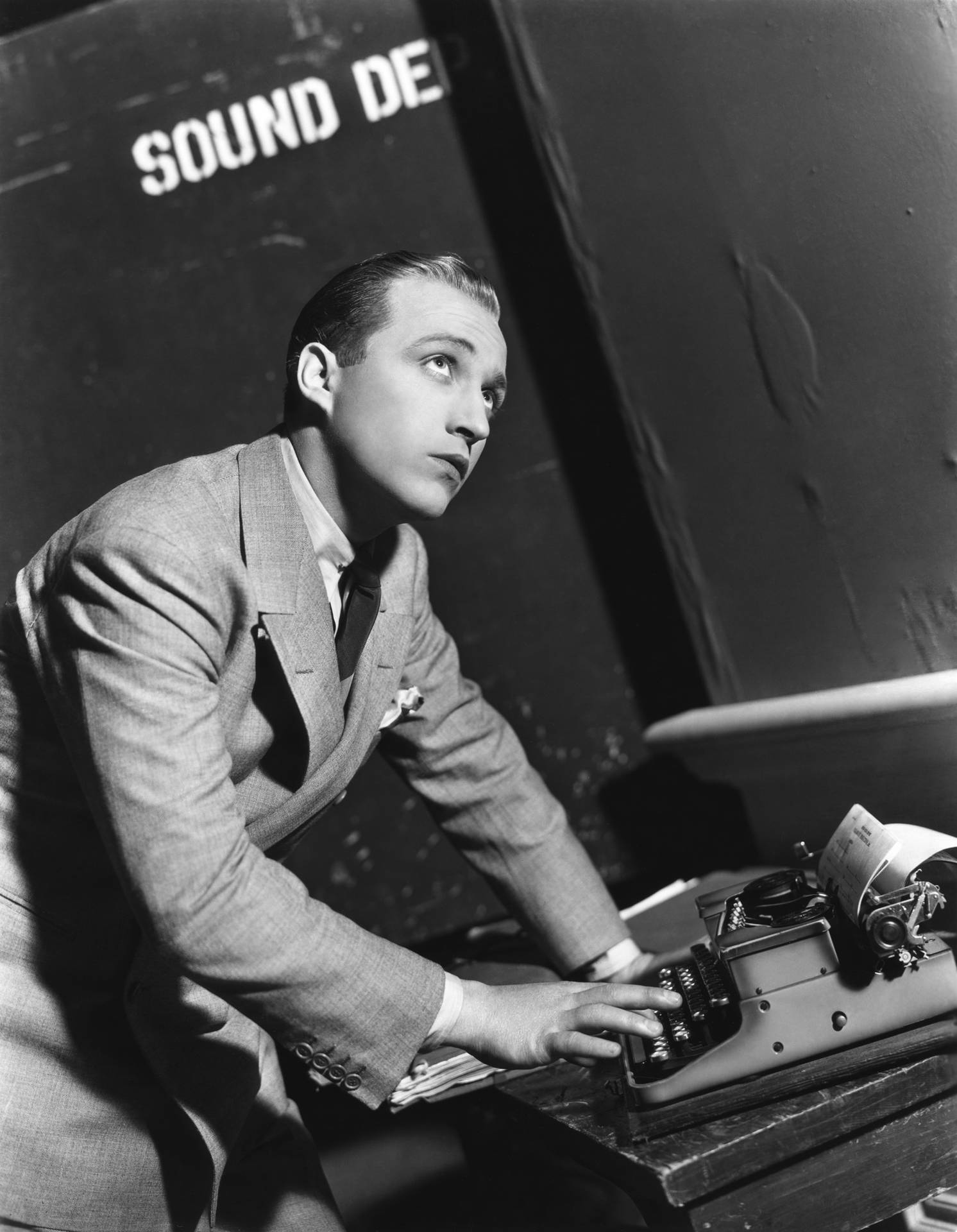 Bing Crosby With A Typewriter Background