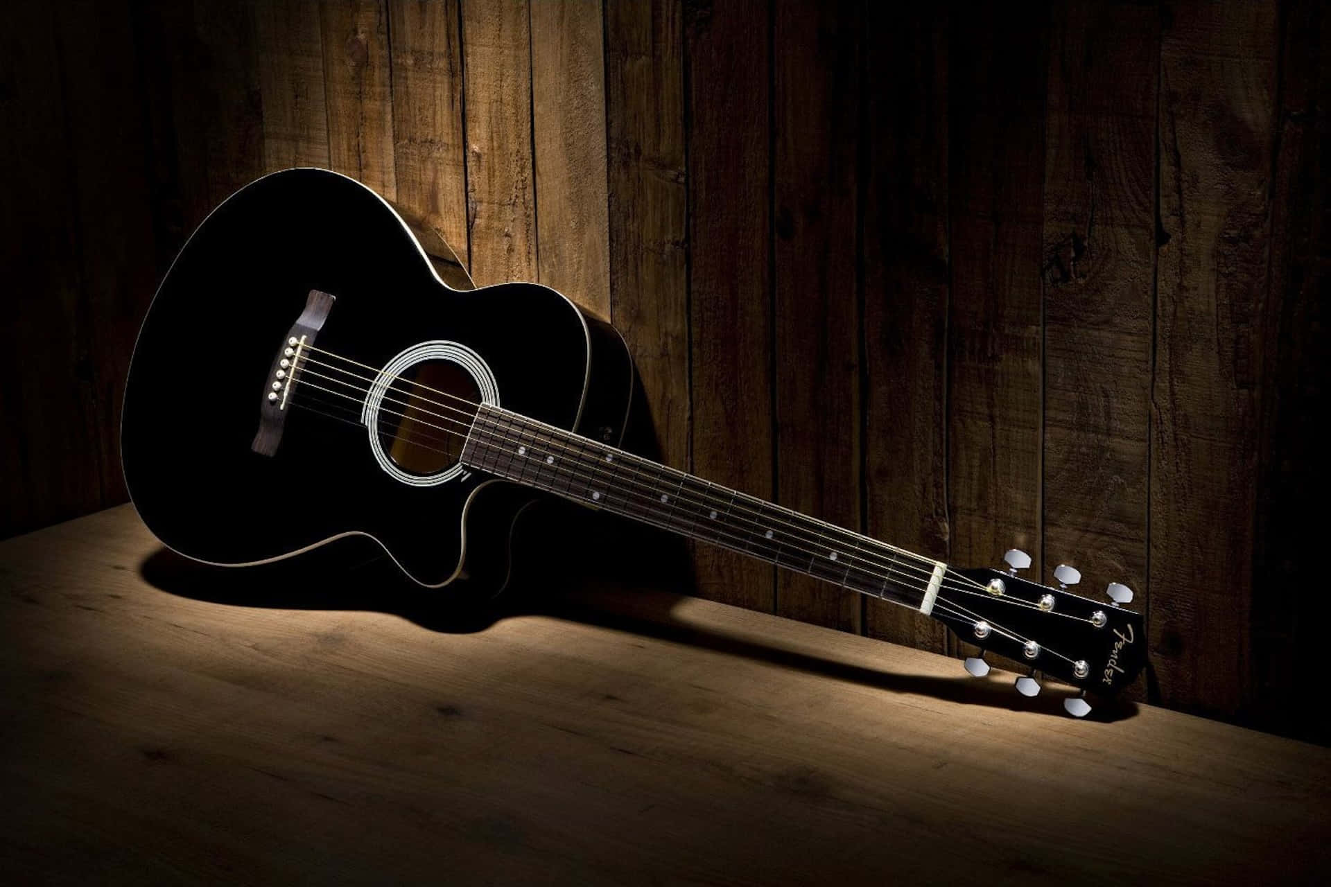 Black Acoustic Guitar Wooden Background