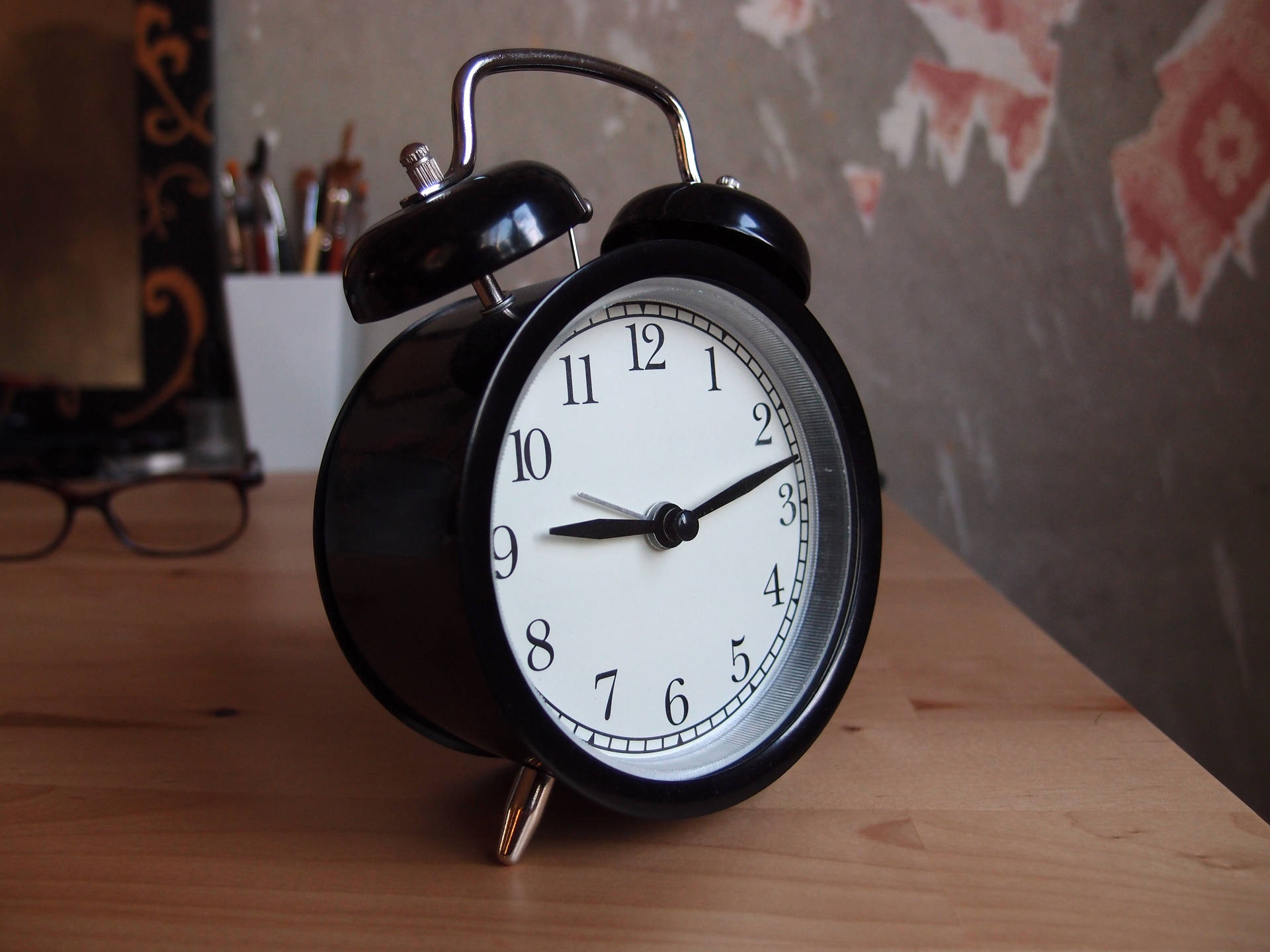 Black Alarm Clock On A Tabletop Background