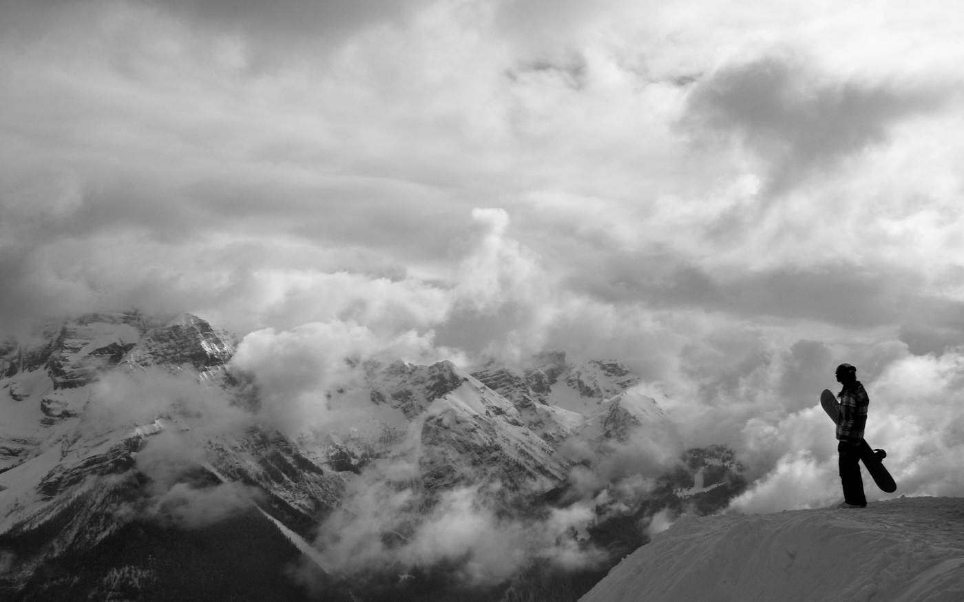 Black And White Man With Snowboard Looking Down