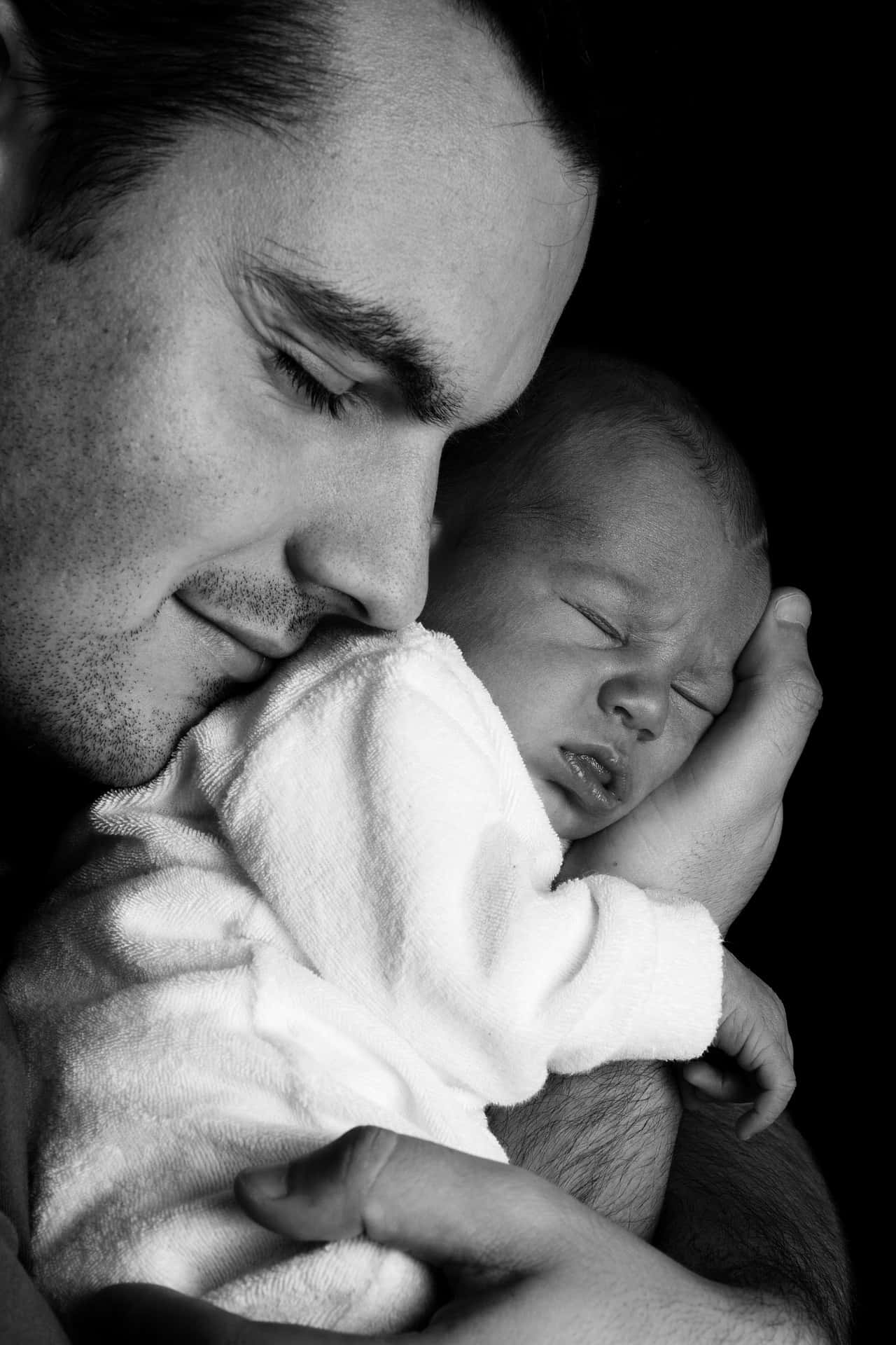 Black And White Photo Of A Father Holding A Newborn Baby Tangible Love Of A Father Background