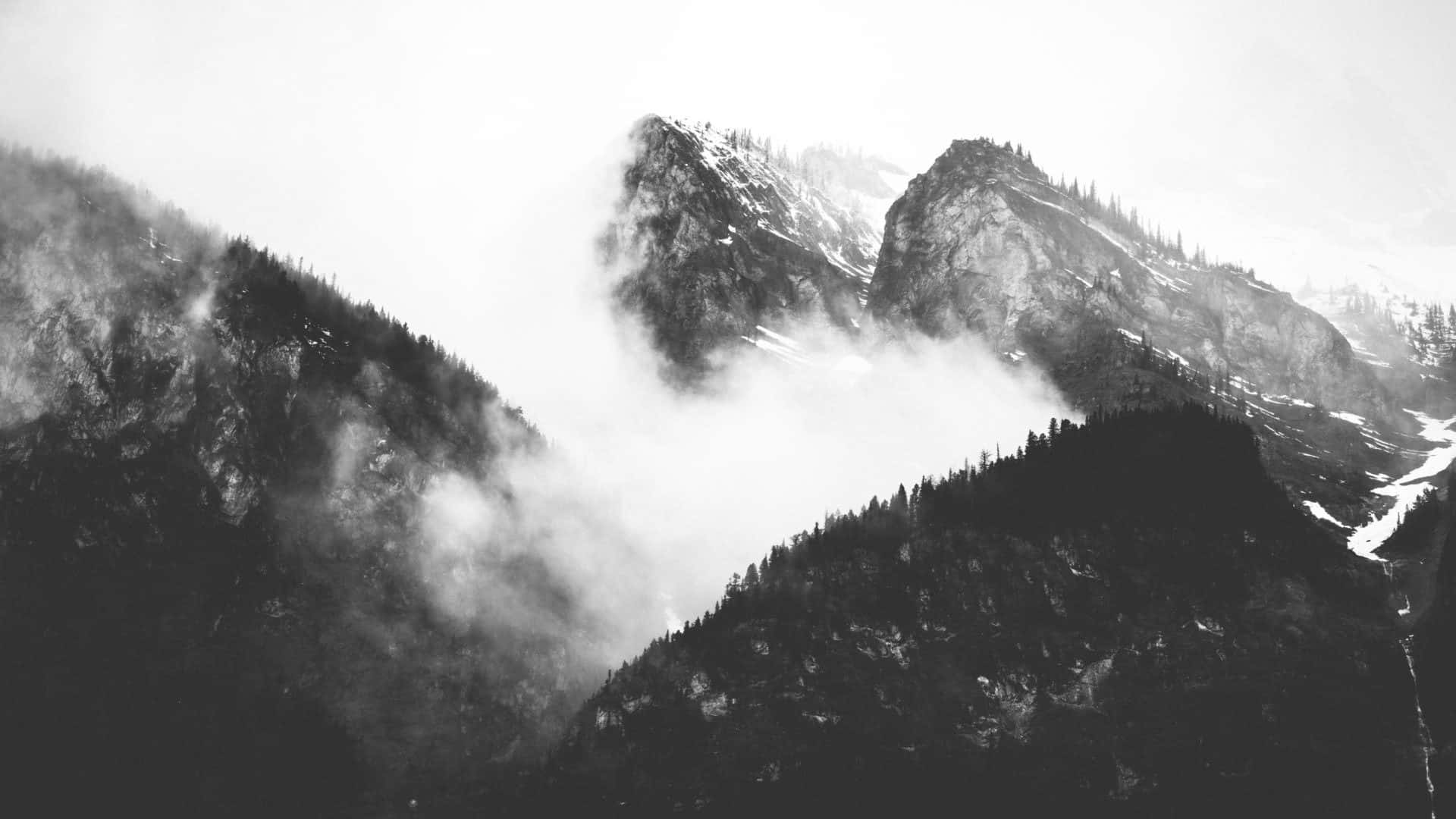 Black And White Photo Of Mountains With Clouds Background