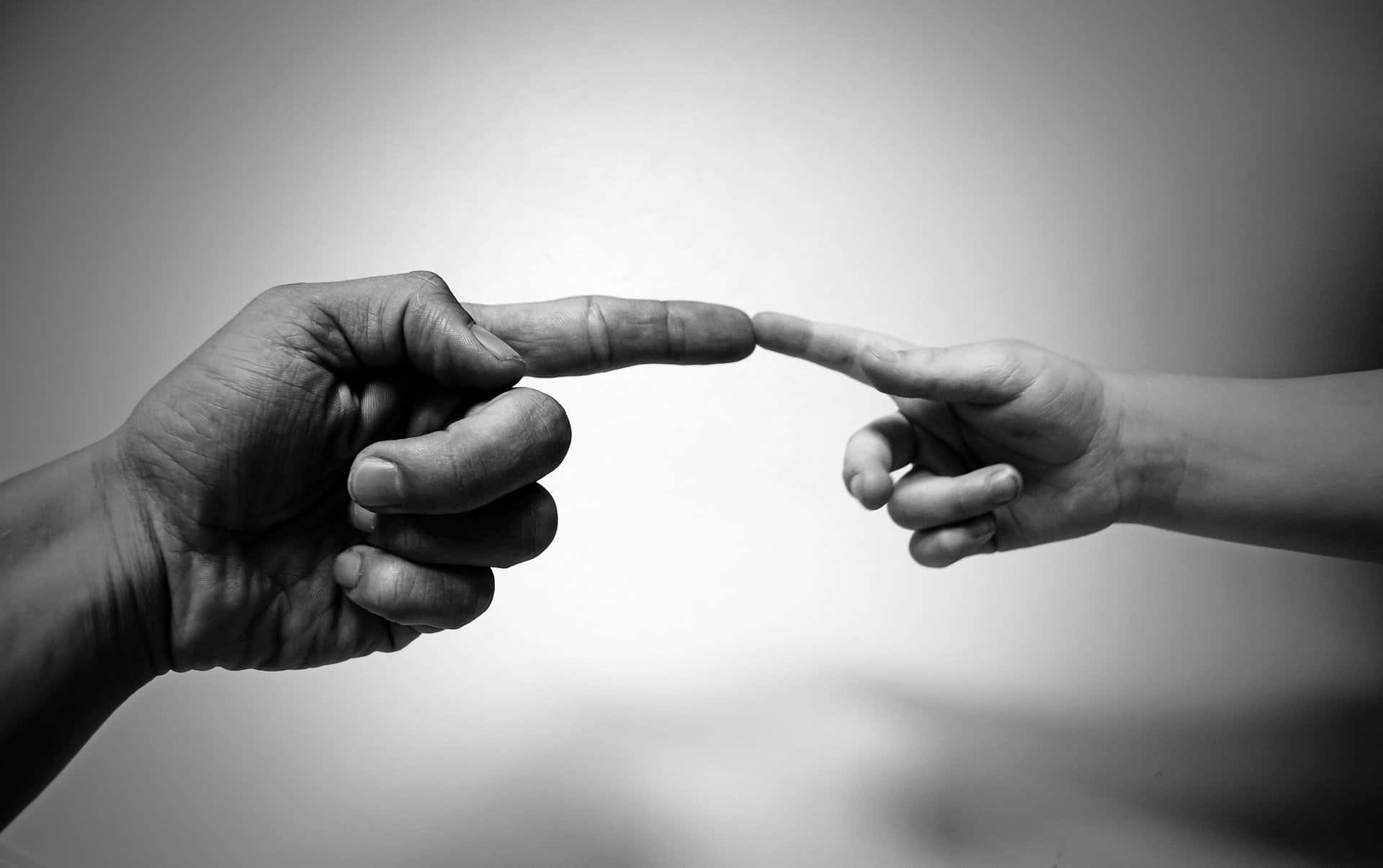 Black And White Photo Of Tangible Touching Of Index Fingers Background