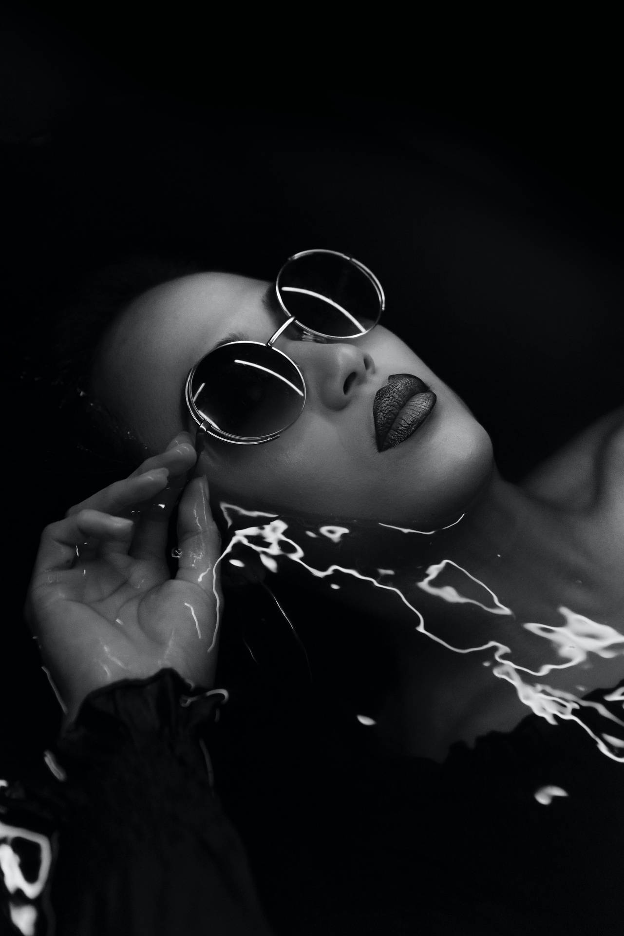 Black And White Portrait Of A Woman Floating On Water Background