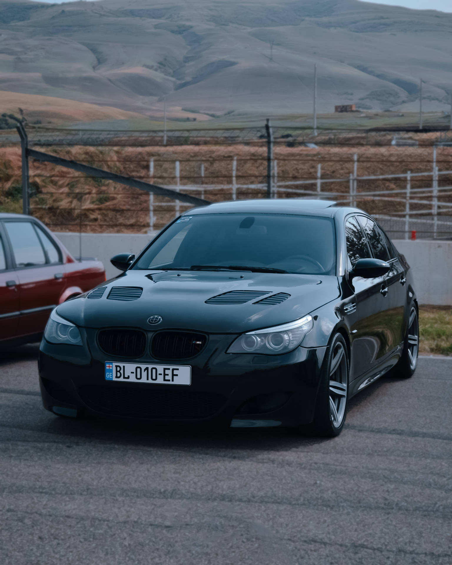 Black Bmw M5 At Racing Track Background