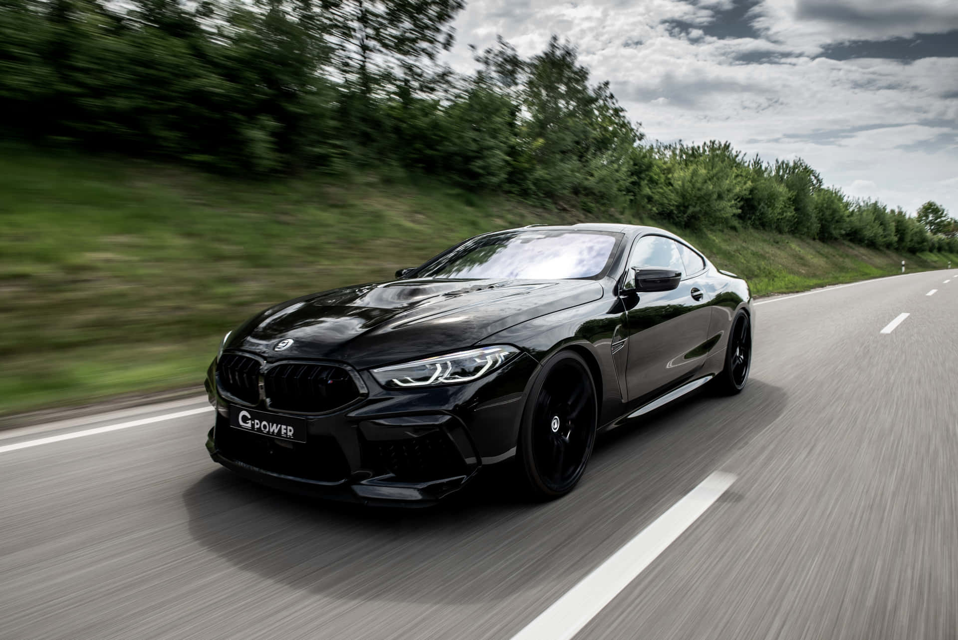 Black Bmw M8 On The Road 4k Background