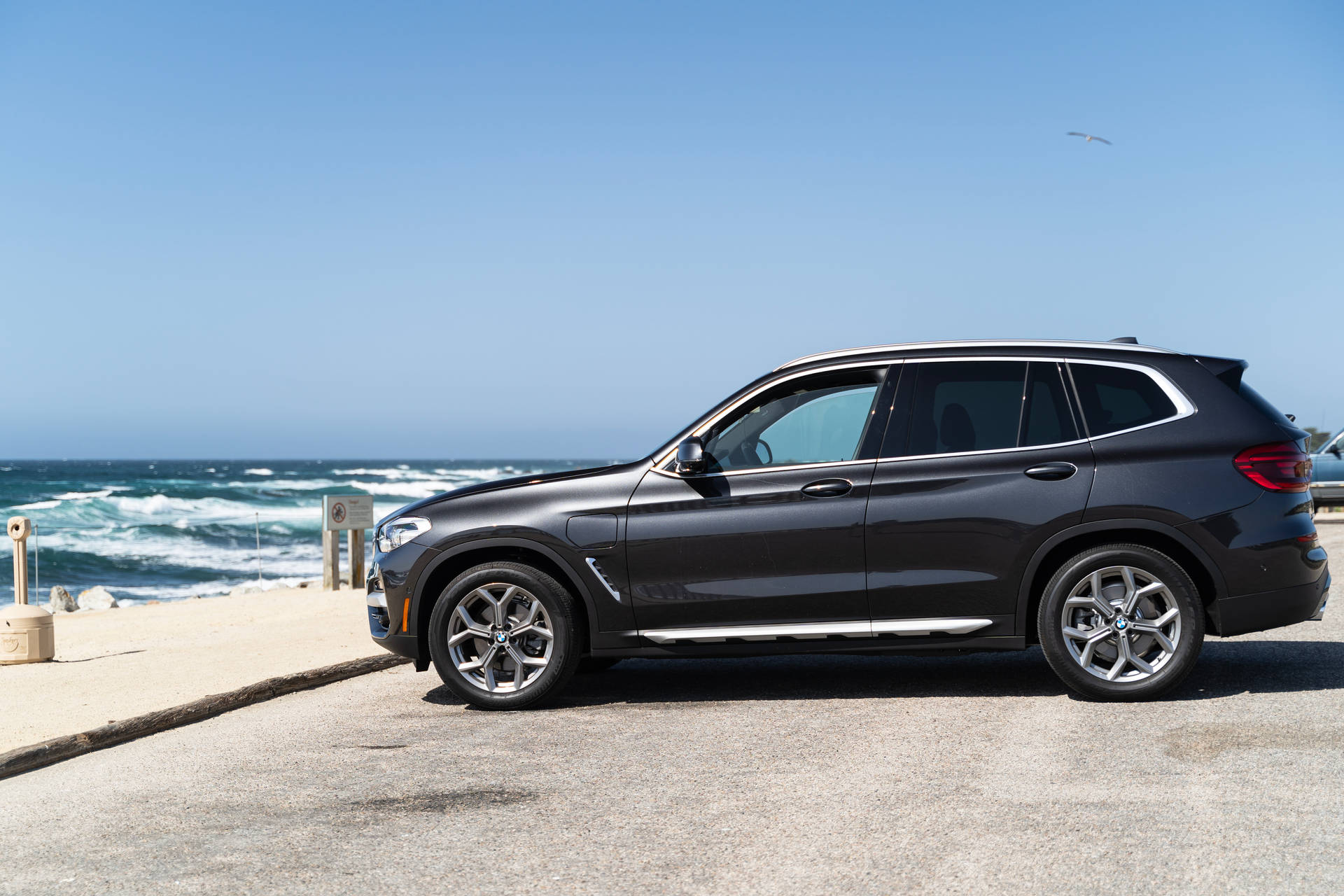 Black Bmw Parked At The Beach Background