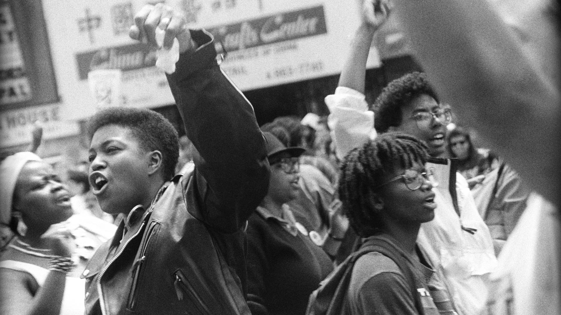 Black Gay Man Participating In Pride Parade 1991 Background