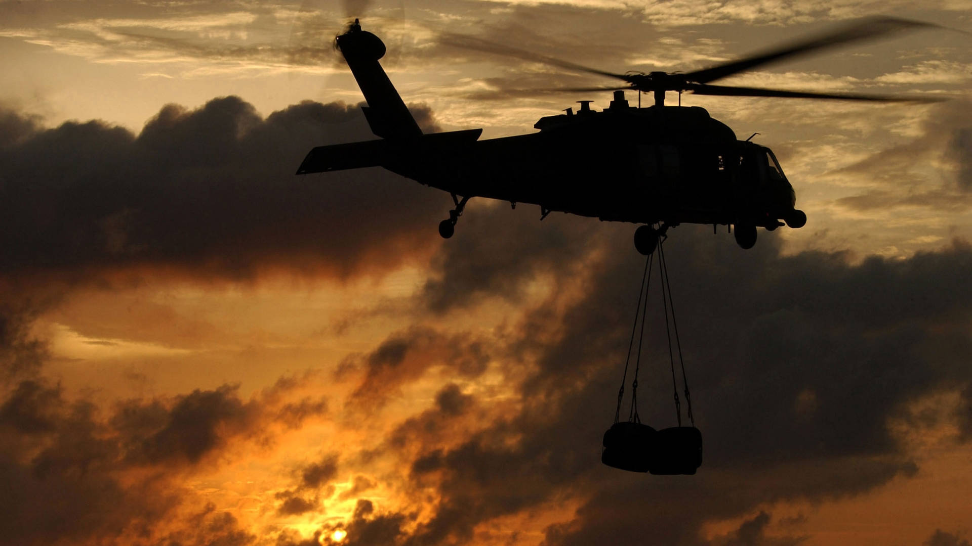 Black Hawk Helicopter Carrying Supplies Background