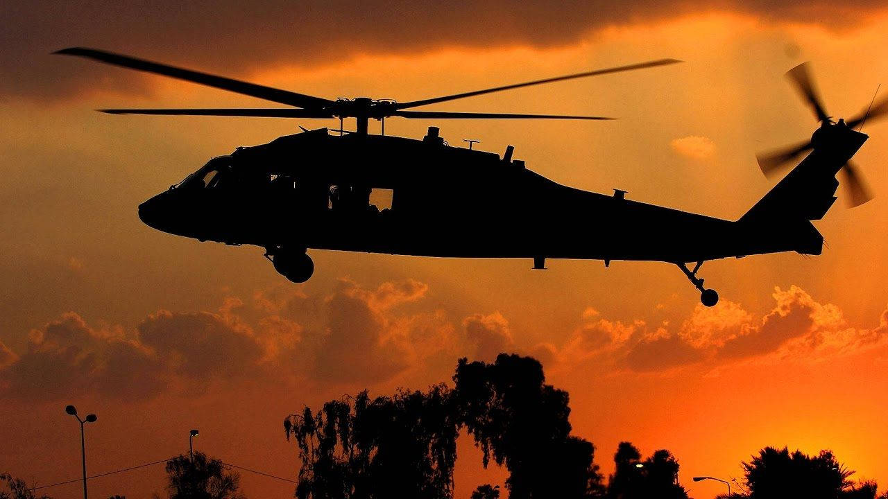 Black Hawk Helicopter Silhouette During Sunset Background