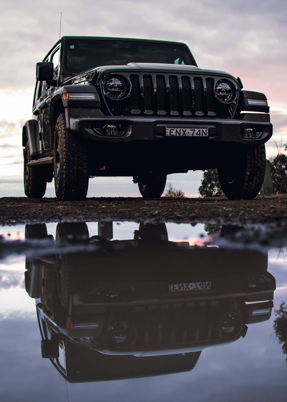 Black Jeep Wrangler Reflection On Water Background