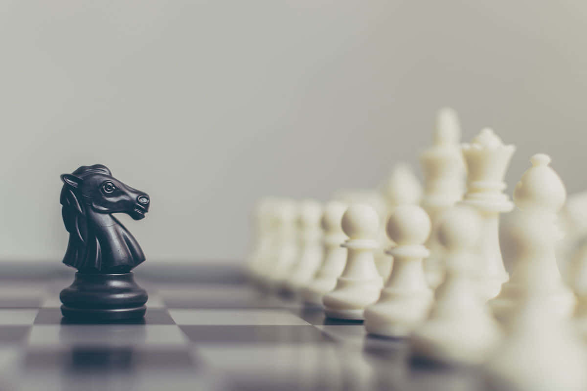 Black Knight Standing Against White Chess Pieces Background