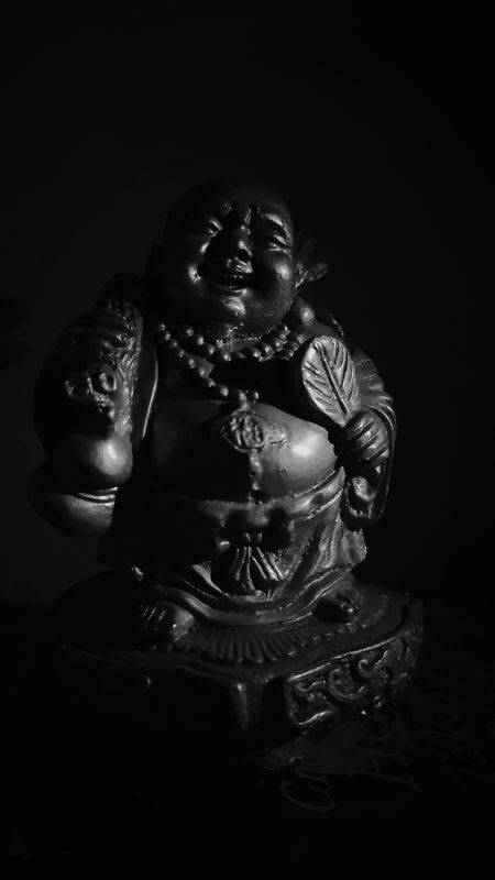 Black Laughing Buddha Statue Background