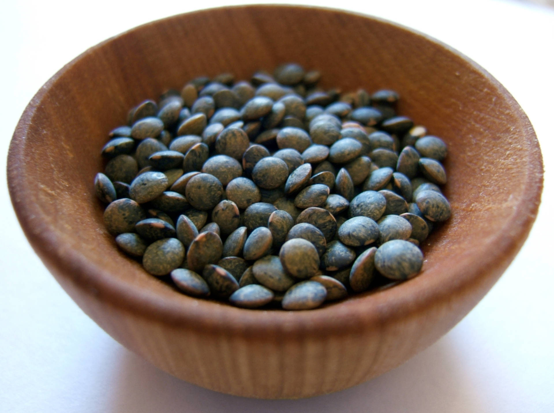 Black Lentils In Wooden Bowl