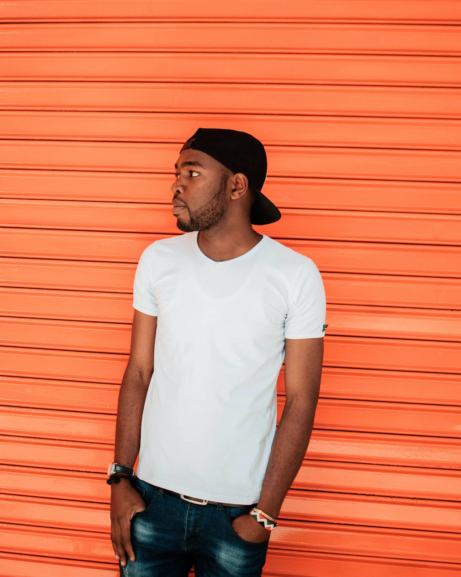 Black Man Against An Orange Backdrop Background