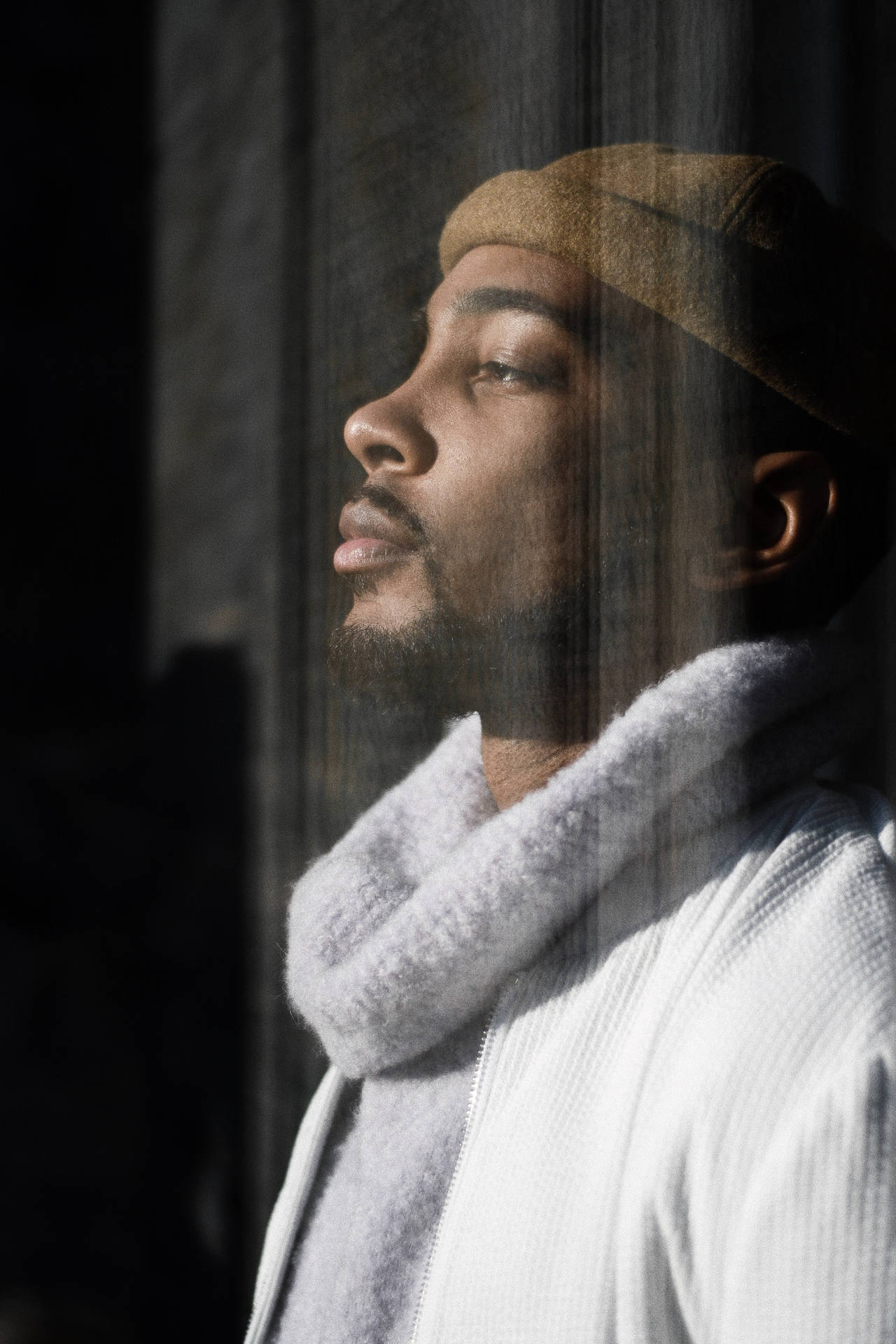 Black Man By A Glass Window Background