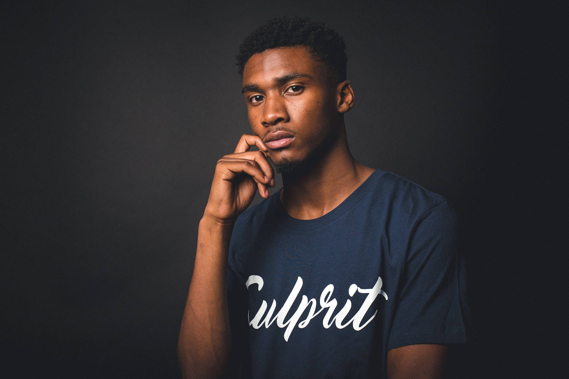 Black Man In Culprit Navy Blue Shirt Background