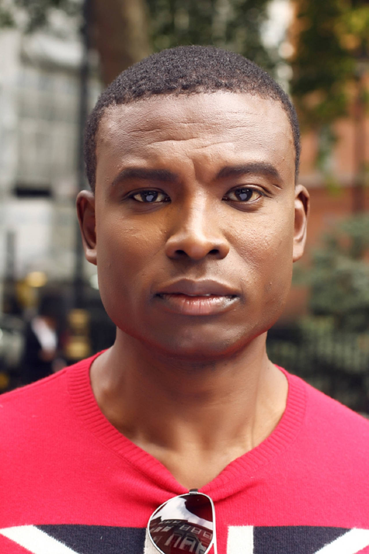 Black Man In Red And On The Street Background