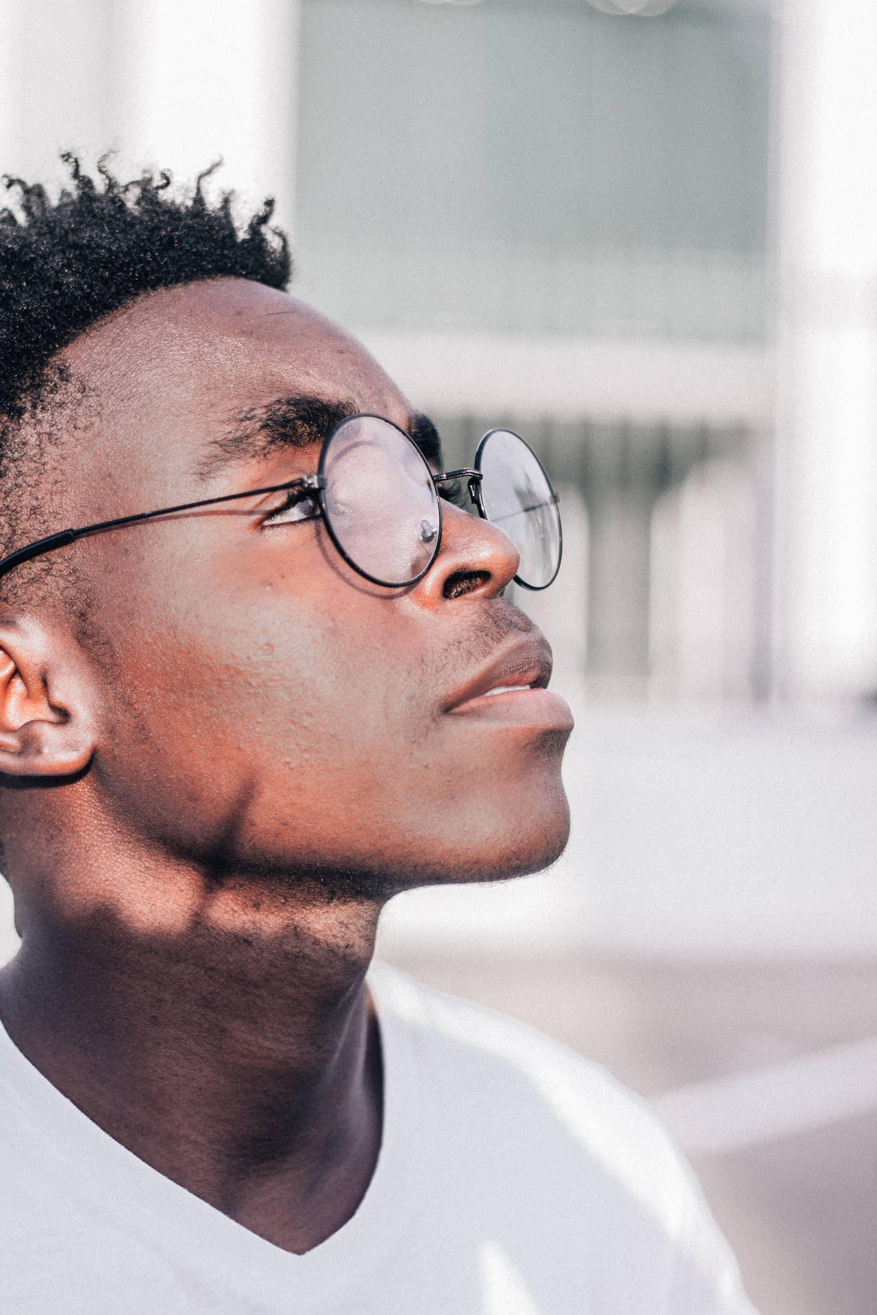 Black Man With Glasses On Out Under The Sun Background