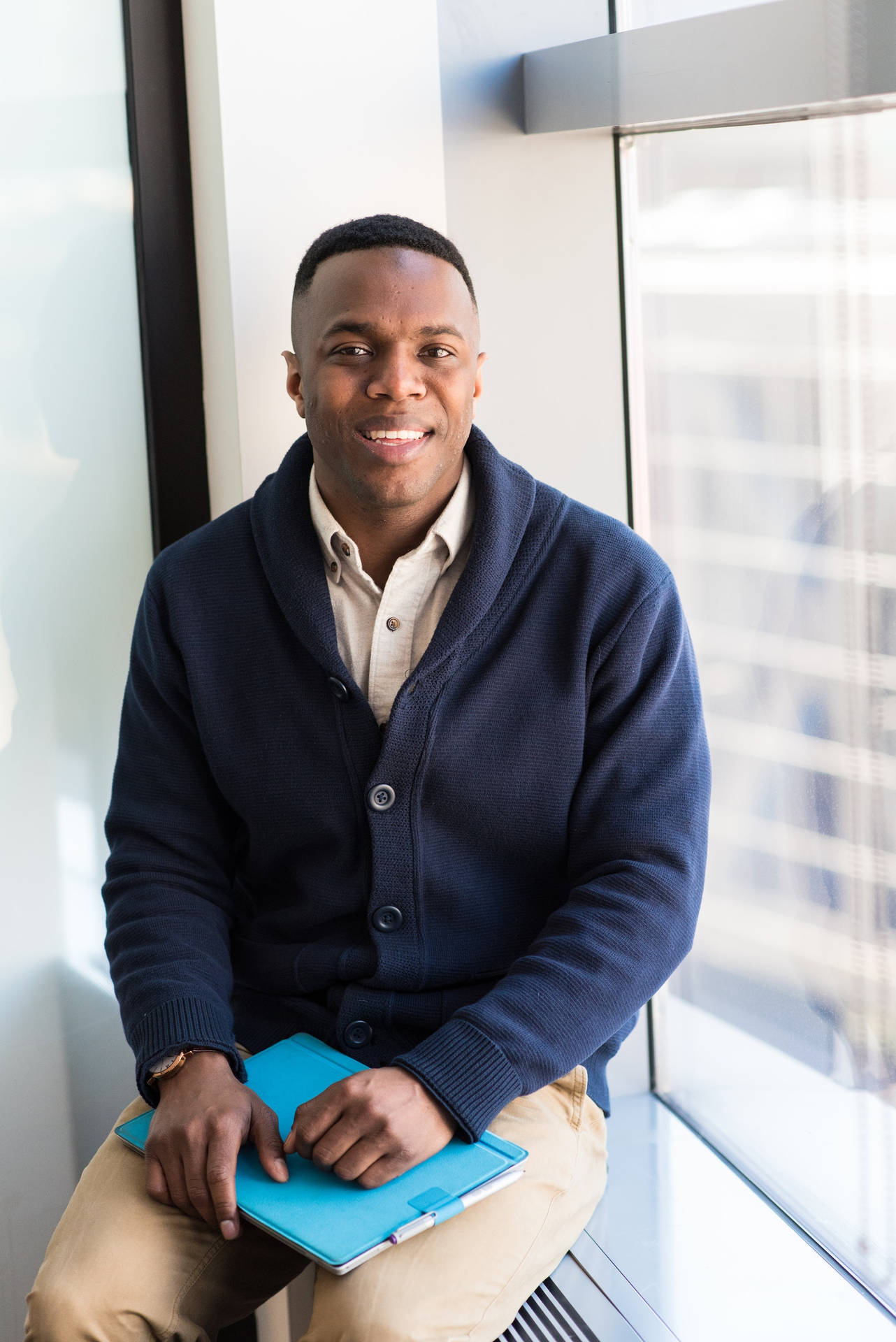 Black Man With Navy Blue Knitted Sweater On Background